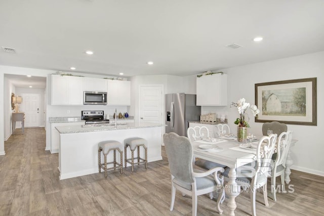 dining space featuring light hardwood / wood-style floors