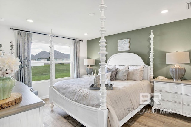 bedroom with hardwood / wood-style floors