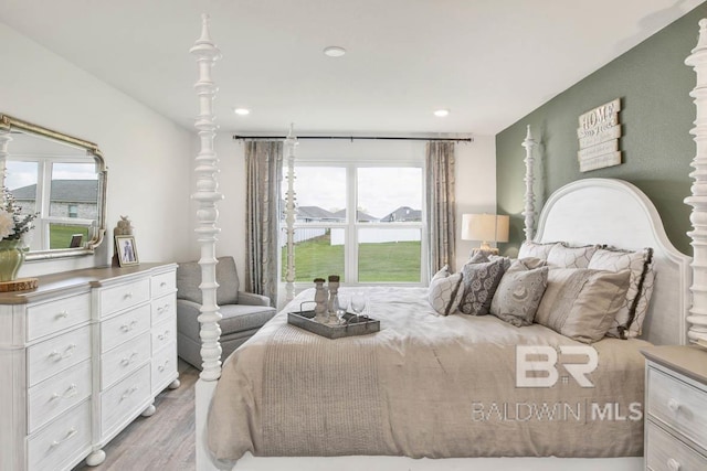 bedroom featuring light hardwood / wood-style floors and multiple windows