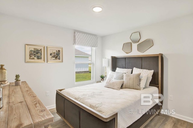 bedroom with hardwood / wood-style flooring