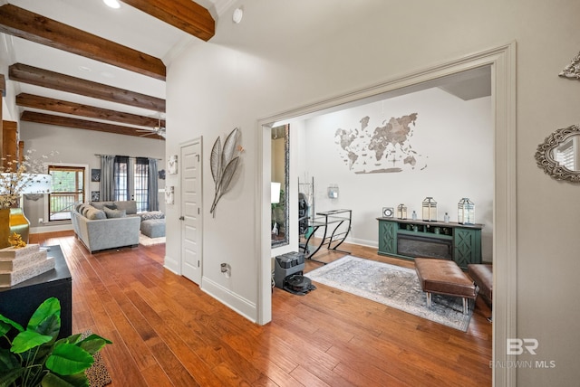 corridor with wood-type flooring and beam ceiling