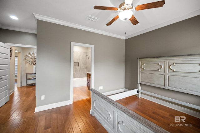 unfurnished bedroom featuring connected bathroom, crown molding, light hardwood / wood-style floors, and ceiling fan