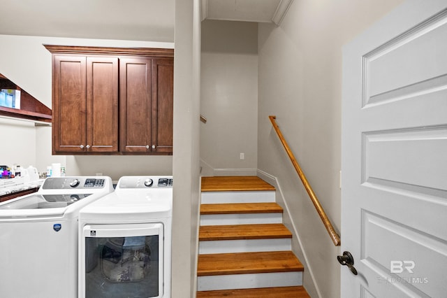 laundry room featuring cabinets and washer and clothes dryer