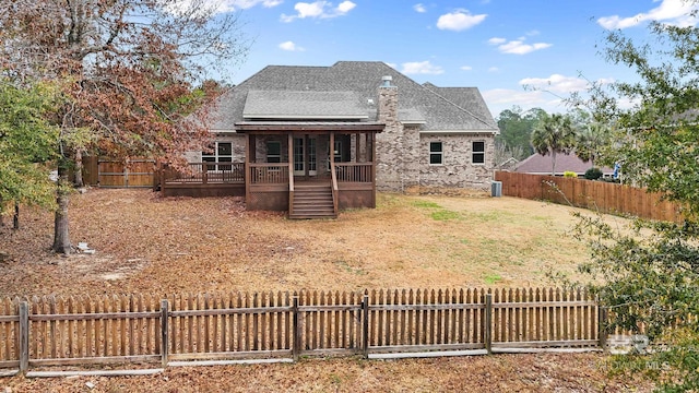 rear view of property with a wooden deck and a sunroom