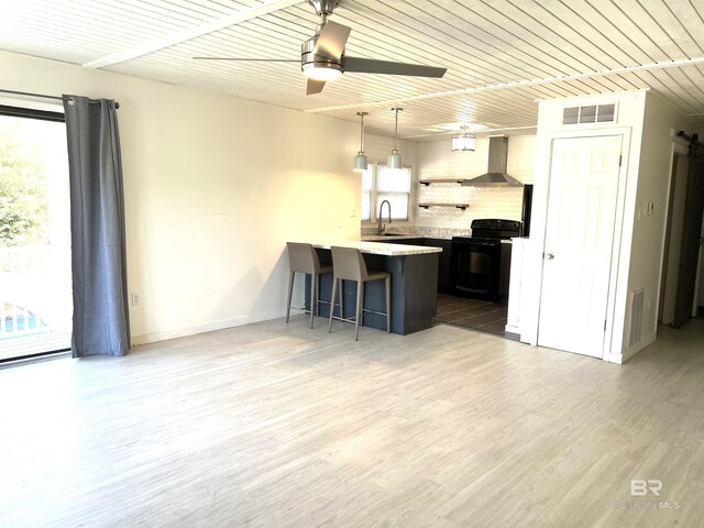 6 Yacht Club Dr Unit 115A, Daphne, AL 36526 - kitchen featuring a wealth of natural light, a kitchen bar, wall chimney range hood, visible vents, and black electric range