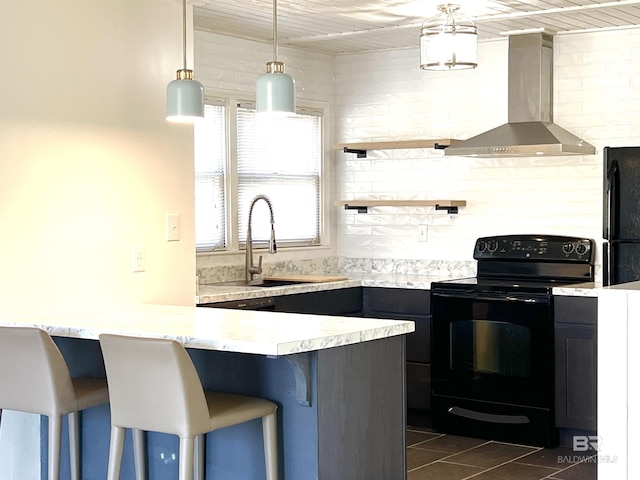 6 Yacht Club Dr Unit 115A, Daphne, AL 36526 - kitchen with light countertops, black appliances, wall chimney exhaust hood, a kitchen bar, and a sink
