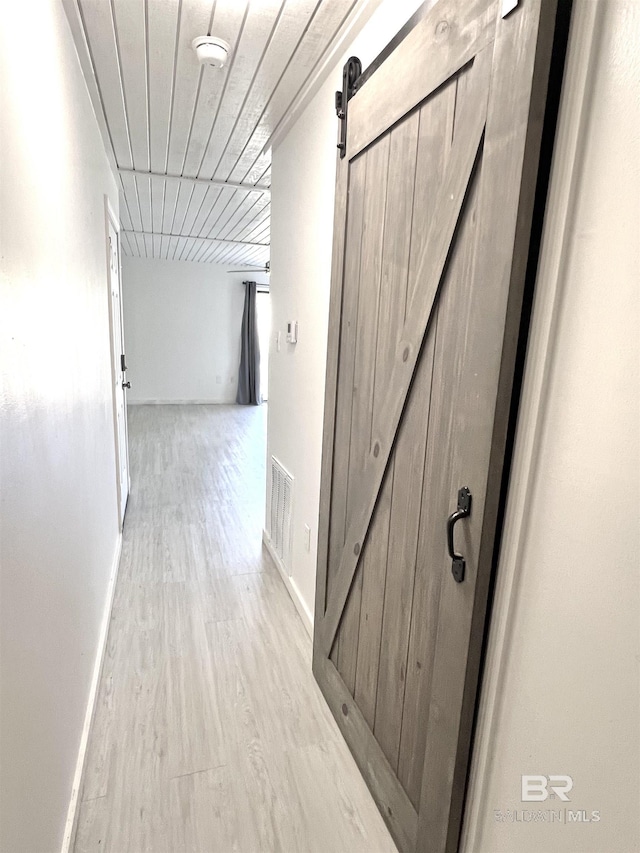 6 Yacht Club Dr Unit 115A, Daphne, AL 36526 - hallway with a barn door, light wood finished floors, visible vents, and baseboards