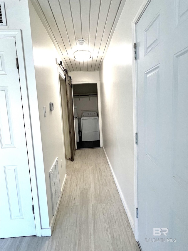 6 Yacht Club Dr Unit 115A, Daphne, AL 36526 - hall with visible vents, a barn door, washing machine and clothes dryer, light wood finished floors, and baseboards