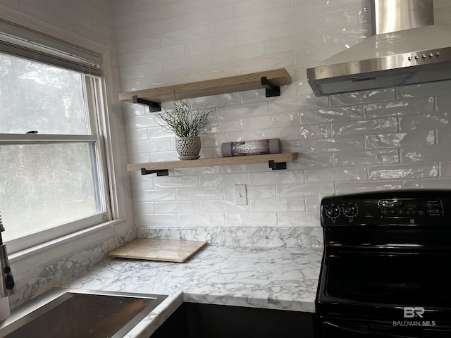 6 Yacht Club Dr Unit 115A, Daphne, AL 36526 - kitchen featuring tasteful backsplash, wall chimney range hood, open shelves, and black range with electric cooktop