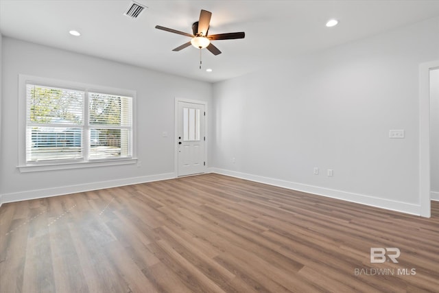 unfurnished room with hardwood / wood-style flooring and ceiling fan