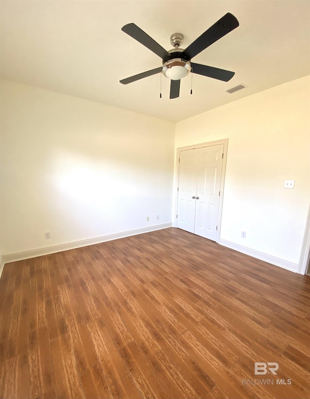 unfurnished bedroom featuring dark hardwood / wood-style floors and ceiling fan