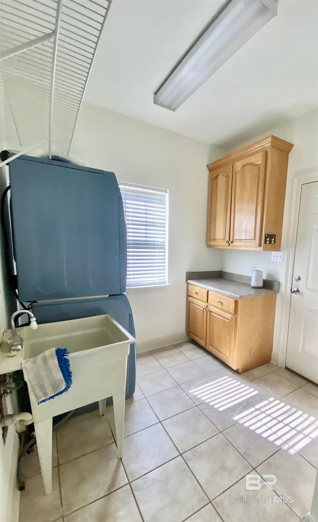 interior space with light tile patterned floors and cabinets