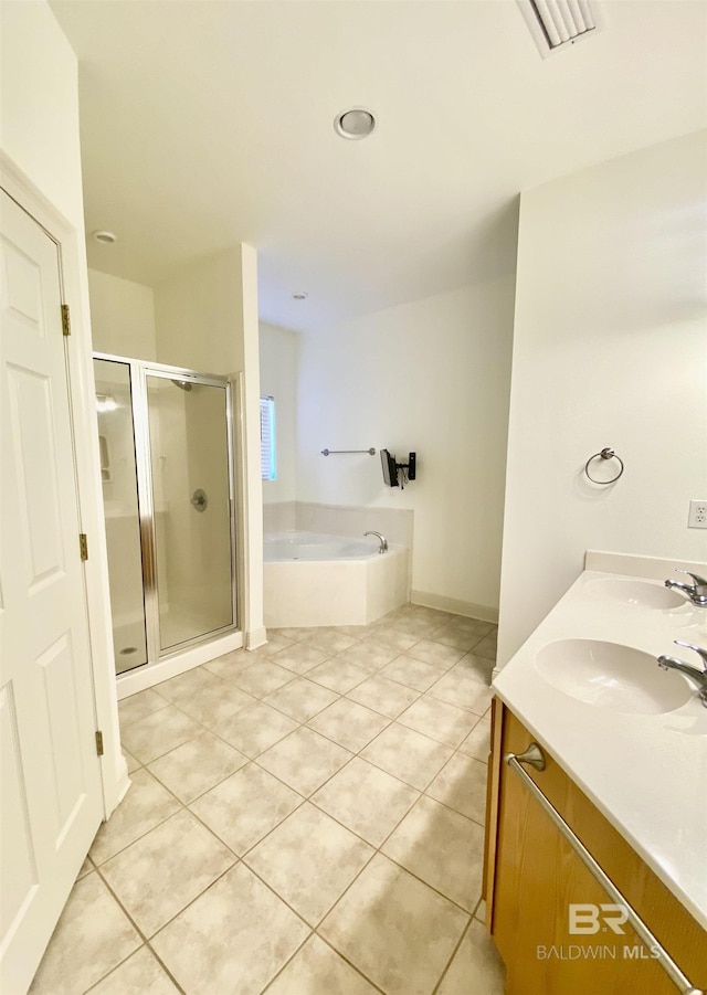 bathroom with vanity, tile patterned flooring, and plus walk in shower