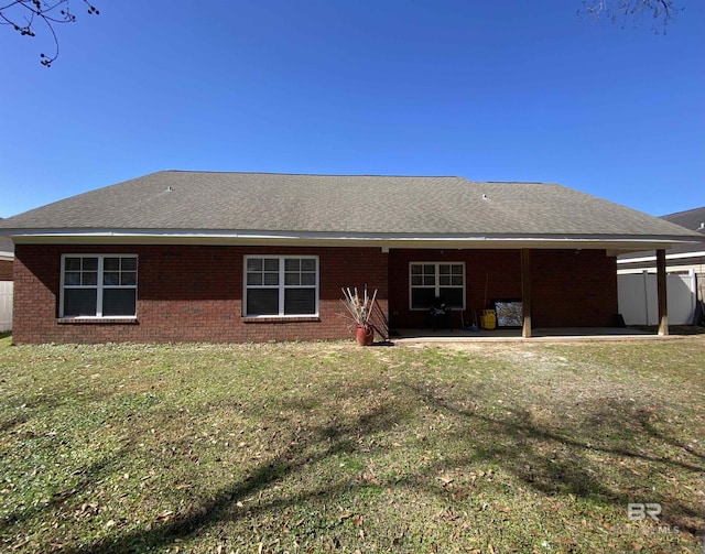 rear view of property featuring a yard and a patio