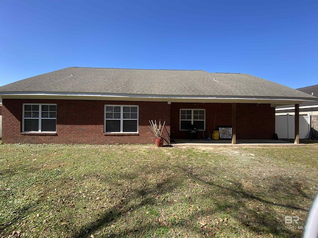 back of house featuring a yard and a patio area