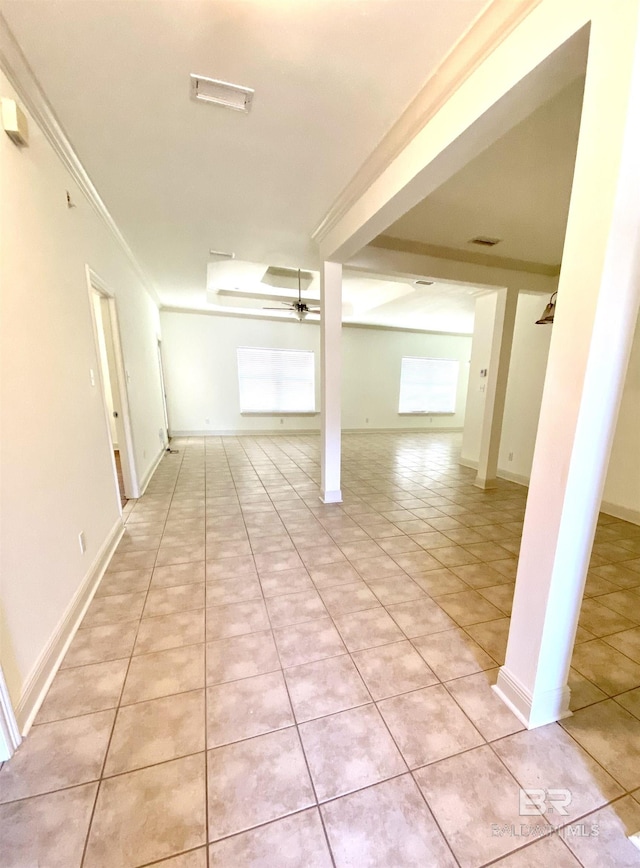 hall featuring crown molding and light tile patterned flooring