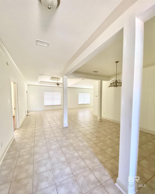 empty room with ceiling fan with notable chandelier and light tile patterned floors