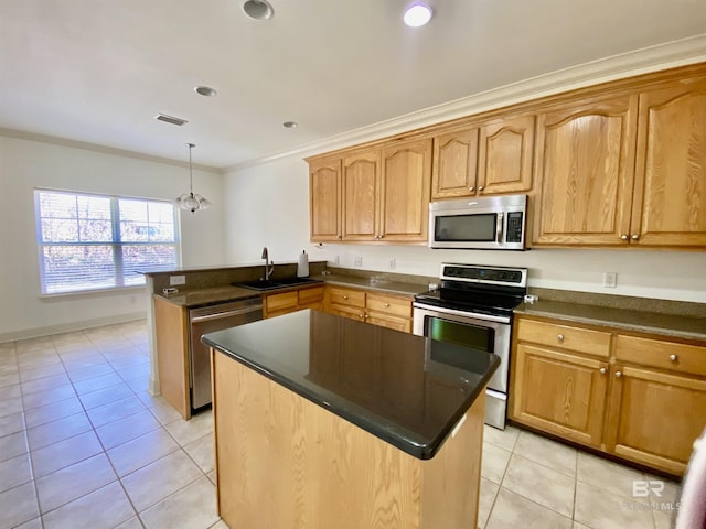 kitchen featuring sink, crown molding, light tile patterned floors, appliances with stainless steel finishes, and hanging light fixtures