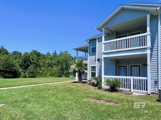 6194 Gulf Shores Pkwy Unit A6, Gulf Shores, AL 36542 - view of side of property with a balcony, a lawn, and covered porch