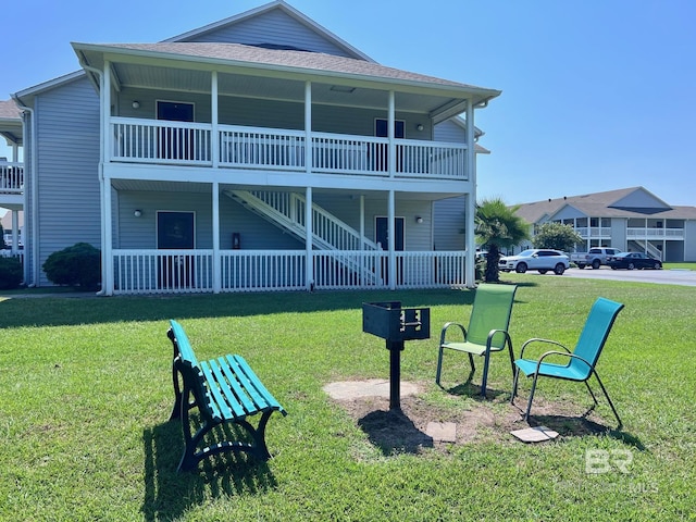 6194 Gulf Shores Pkwy Unit A6, Gulf Shores, AL 36542 - back of property with a yard, a shingled roof, and stairway