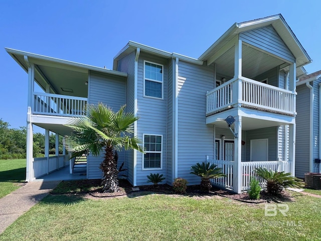 6194 Gulf Shores Pkwy Unit A6, Gulf Shores, AL 36542 - view of side of home featuring a balcony, a lawn, a porch, and cooling unit