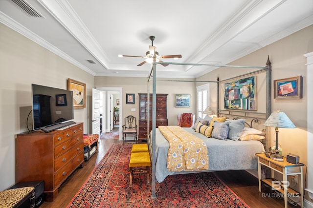 bedroom with crown molding, dark hardwood / wood-style floors, and ceiling fan