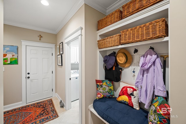 mudroom with washer / dryer, ornamental molding, and light tile patterned floors