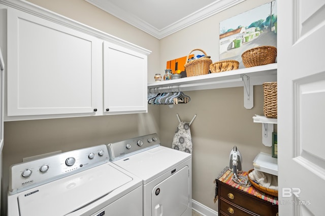 laundry room with ornamental molding, cabinets, and washer and dryer