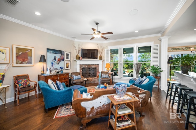 living room with a fireplace, ornamental molding, dark hardwood / wood-style floors, and ceiling fan