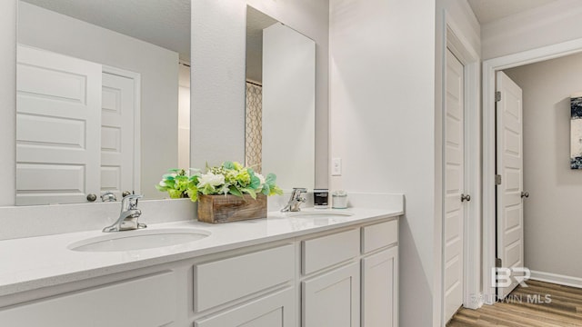 1040 Hayward Loop, Foley, AL 36535 - full bathroom featuring double vanity and wood finished floors