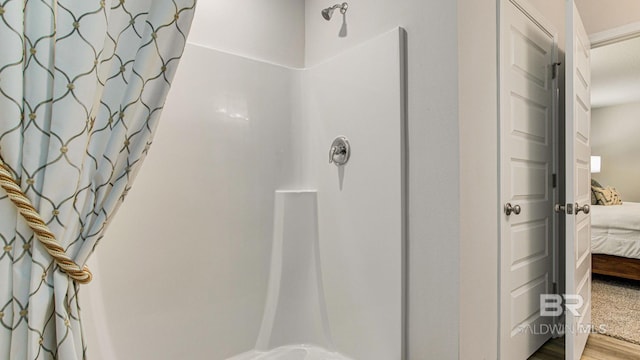 1040 Hayward Loop, Foley, AL 36535 - bathroom featuring ensuite bathroom, a shower with shower curtain, and wood finished floors