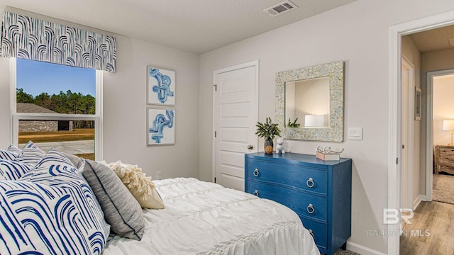1040 Hayward Loop, Foley, AL 36535 - bedroom featuring baseboards and wood finished floors