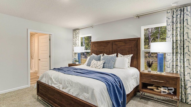 1040 Hayward Loop, Foley, AL 36535 - carpeted bedroom with a textured ceiling and baseboards