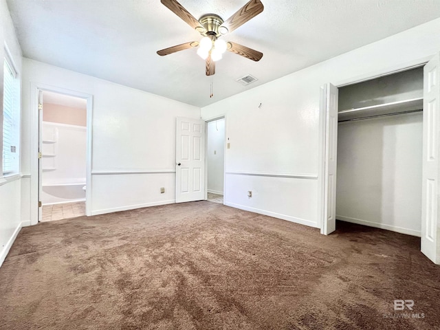 unfurnished bedroom with a closet, baseboards, carpet flooring, ensuite bathroom, and visible vents