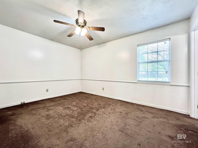 spare room with carpet, a textured ceiling, baseboards, and ceiling fan