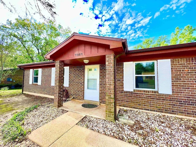 single story home featuring brick siding