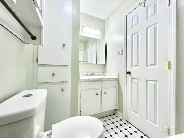 bathroom with tile patterned floors, vanity, and toilet