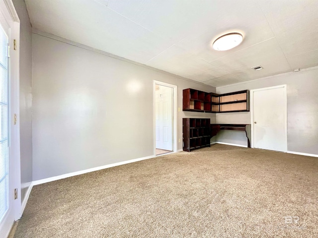 unfurnished bedroom with visible vents, baseboards, and carpet flooring