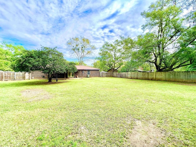 view of yard with a fenced backyard