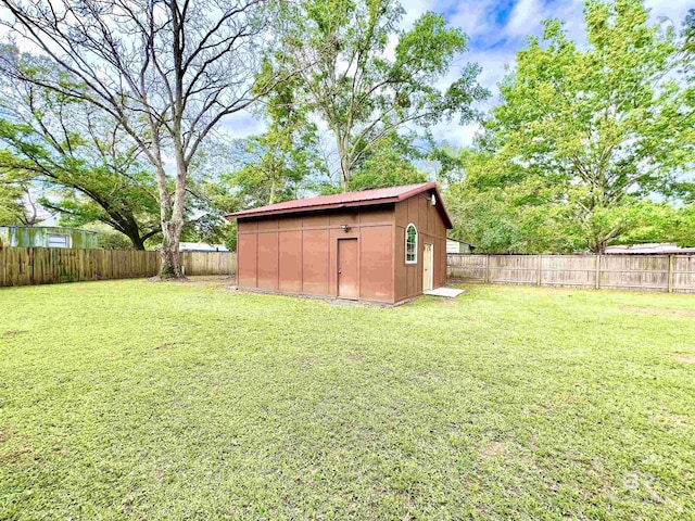 view of yard featuring a fenced backyard, an outbuilding, and a storage unit