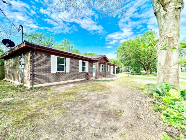 view of front of home featuring brick siding