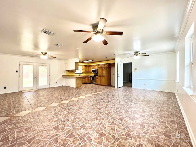 unfurnished living room featuring ornamental molding and ceiling fan