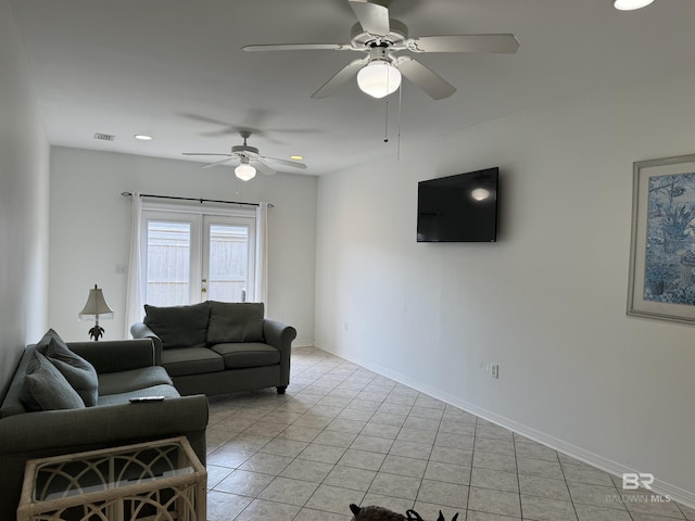 tiled living room featuring ceiling fan and french doors