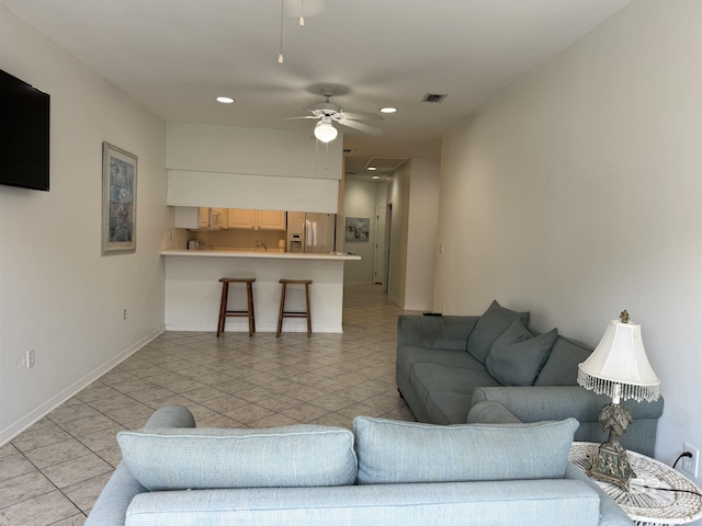 living room featuring ceiling fan and light tile patterned floors