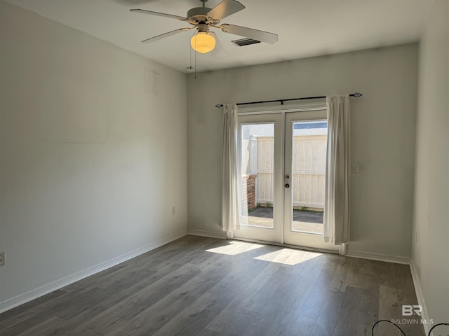 spare room featuring ceiling fan, hardwood / wood-style floors, and french doors