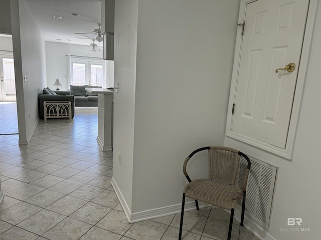 hall featuring light tile patterned floors