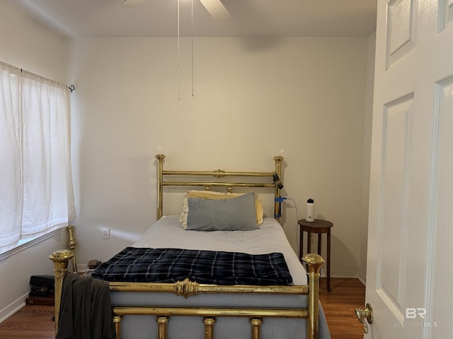 bedroom featuring ceiling fan and dark hardwood / wood-style flooring