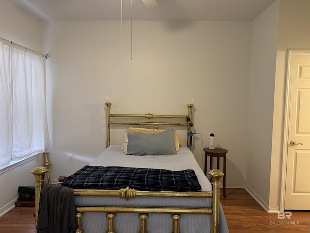 bedroom with ceiling fan and wood-type flooring