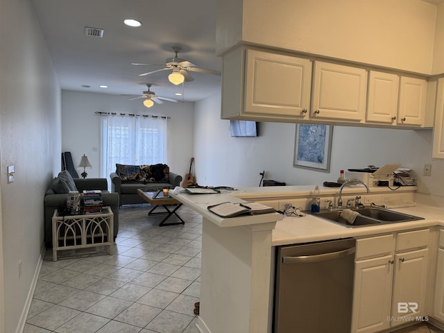 kitchen featuring stainless steel dishwasher, white cabinets, and sink