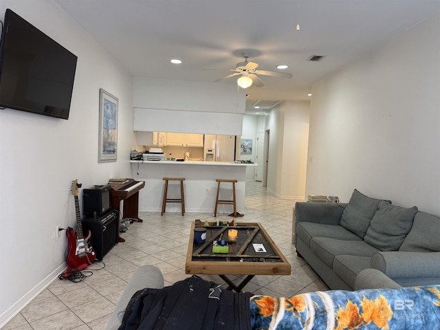 living room with ceiling fan and light tile patterned floors